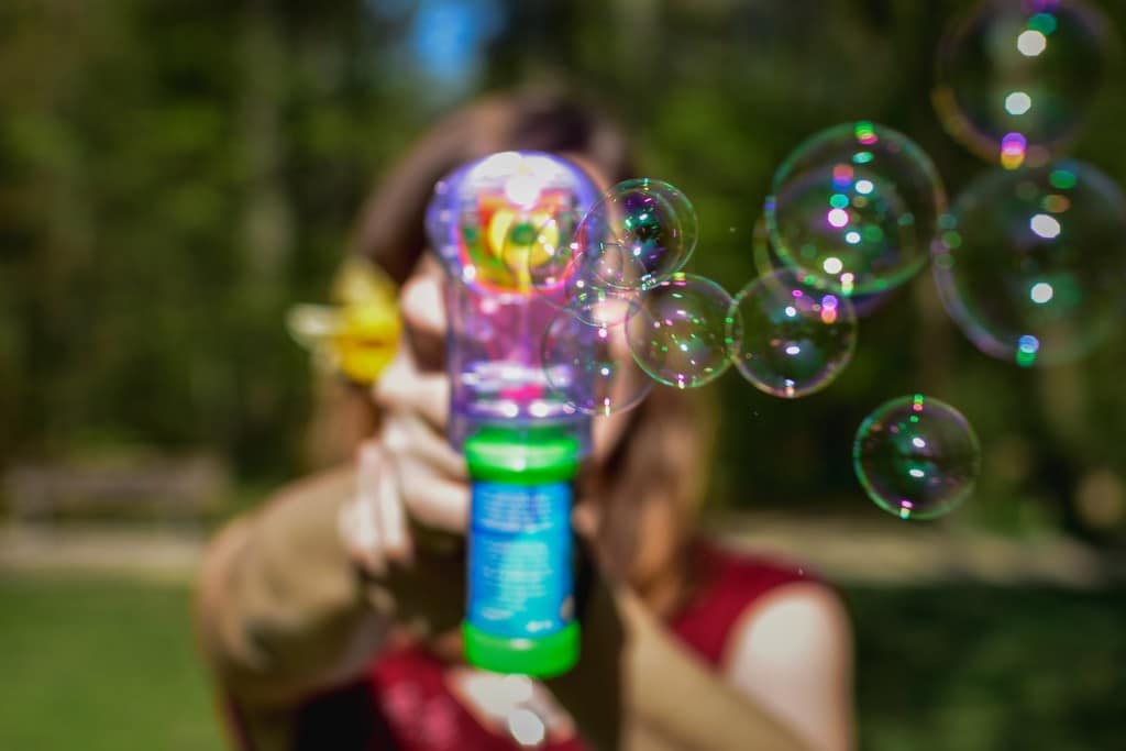 woman with coloured bubble gun shooting the messenger Generative Change Life Changing Coaching Online and by Phone